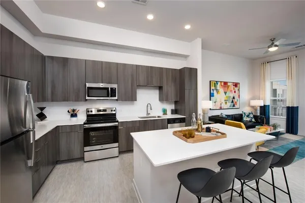 a kitchen with stainless steel appliances granite countertop a sink and stove