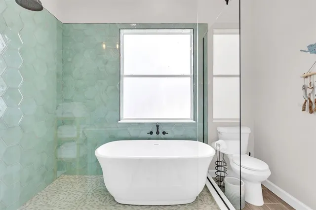 a bathroom with a double vanity sink mirror and toilet