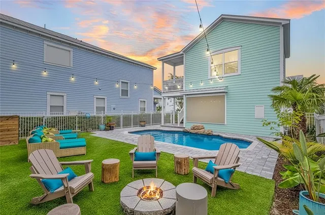 a dining hall with stainless steel appliances kitchen island a table and chairs in it
