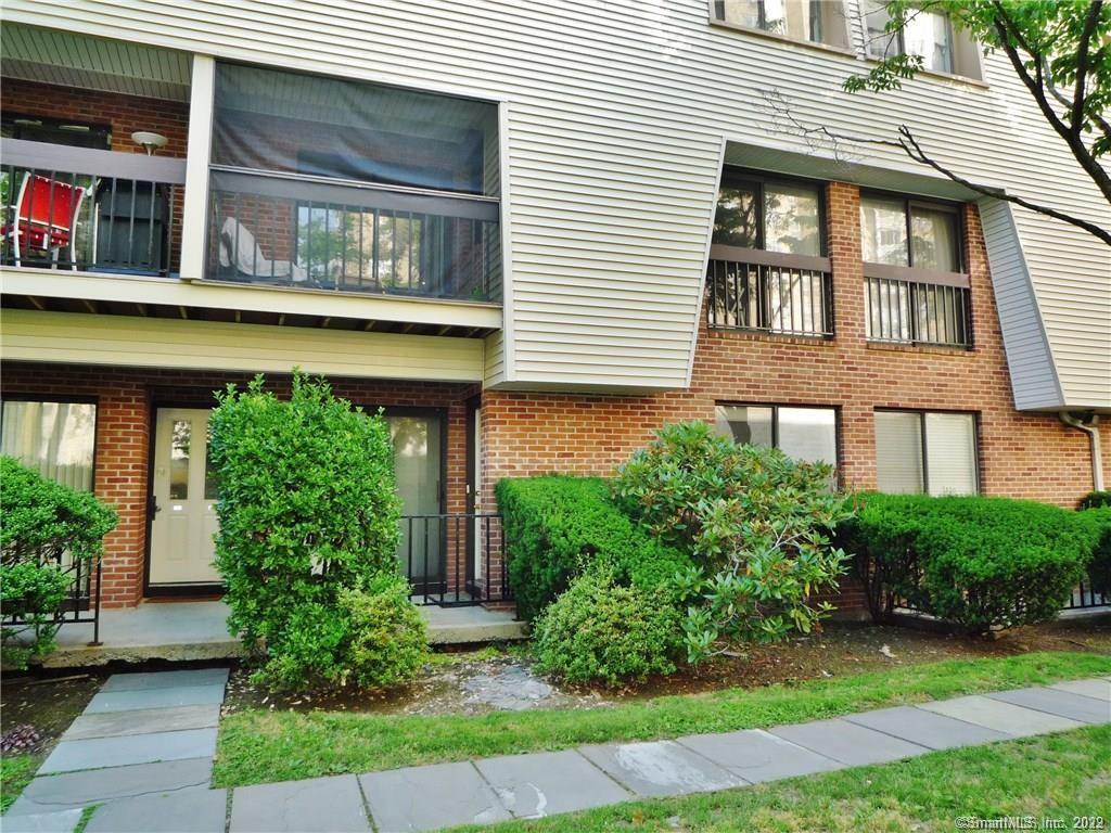 1 Valley Road, Unit 104 Stamford, CT 06902 - Photo 1 of 1 a front view of a house with garden
