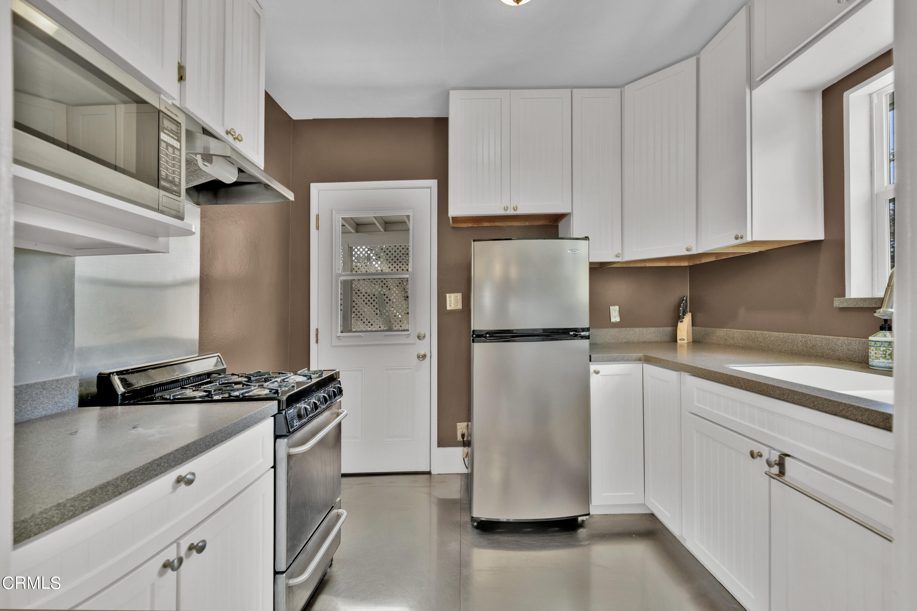 6520 Valmont Street Tujunga, CA 91042 - Photo 18 of 35 a kitchen with a refrigerator a sink and cabinets