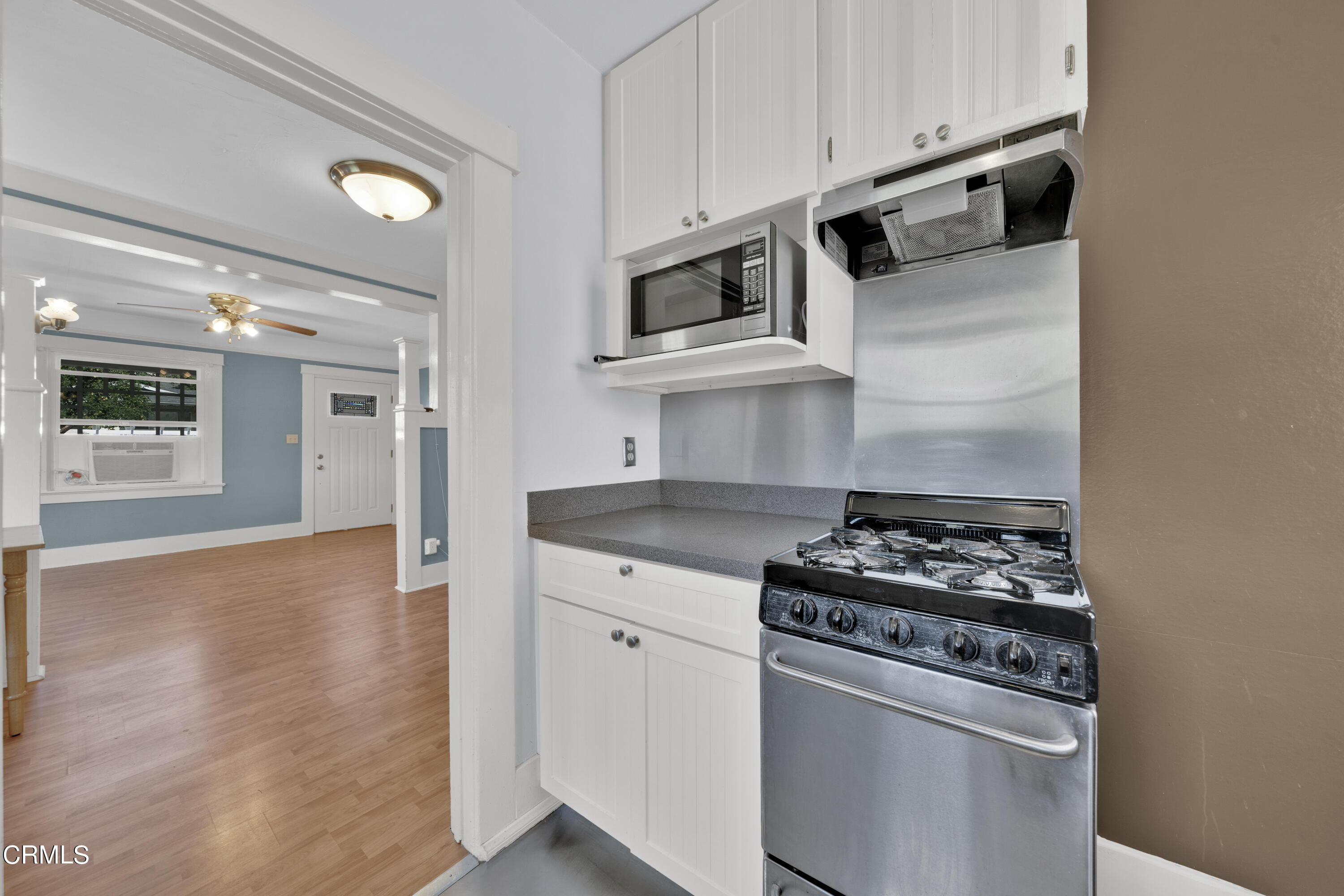 6520 Valmont Street Tujunga, CA 91042 - Photo 20 of 35 a kitchen with stainless steel appliances granite countertop a stove and a microwave