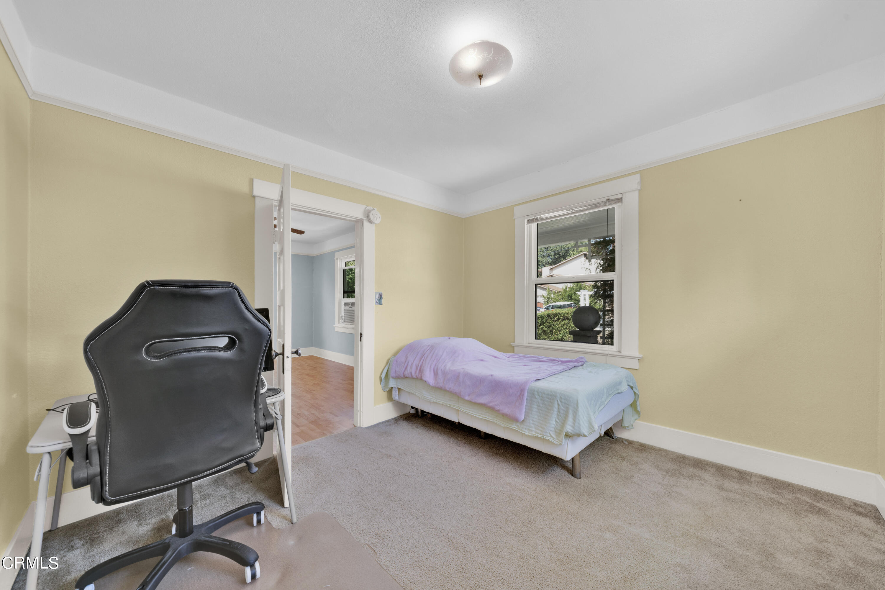 6520 Valmont Street Tujunga, CA 91042 - Photo 22 of 35 a bedroom with a bed and chair