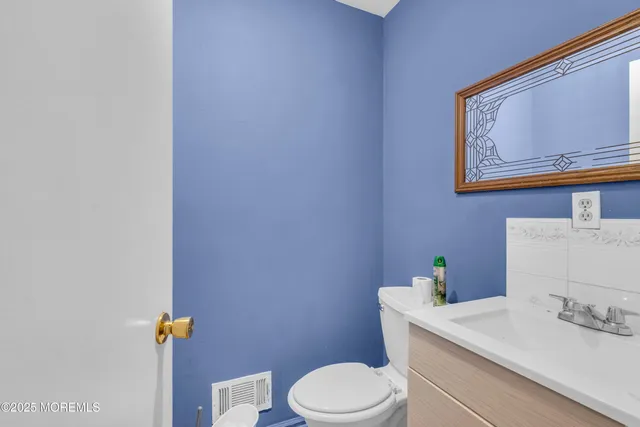 a white toilet sitting next to a bathroom sink