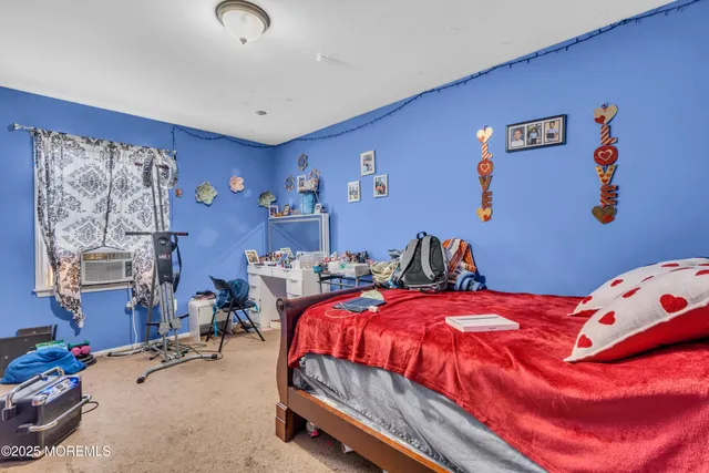 a bedroom with bed and a window