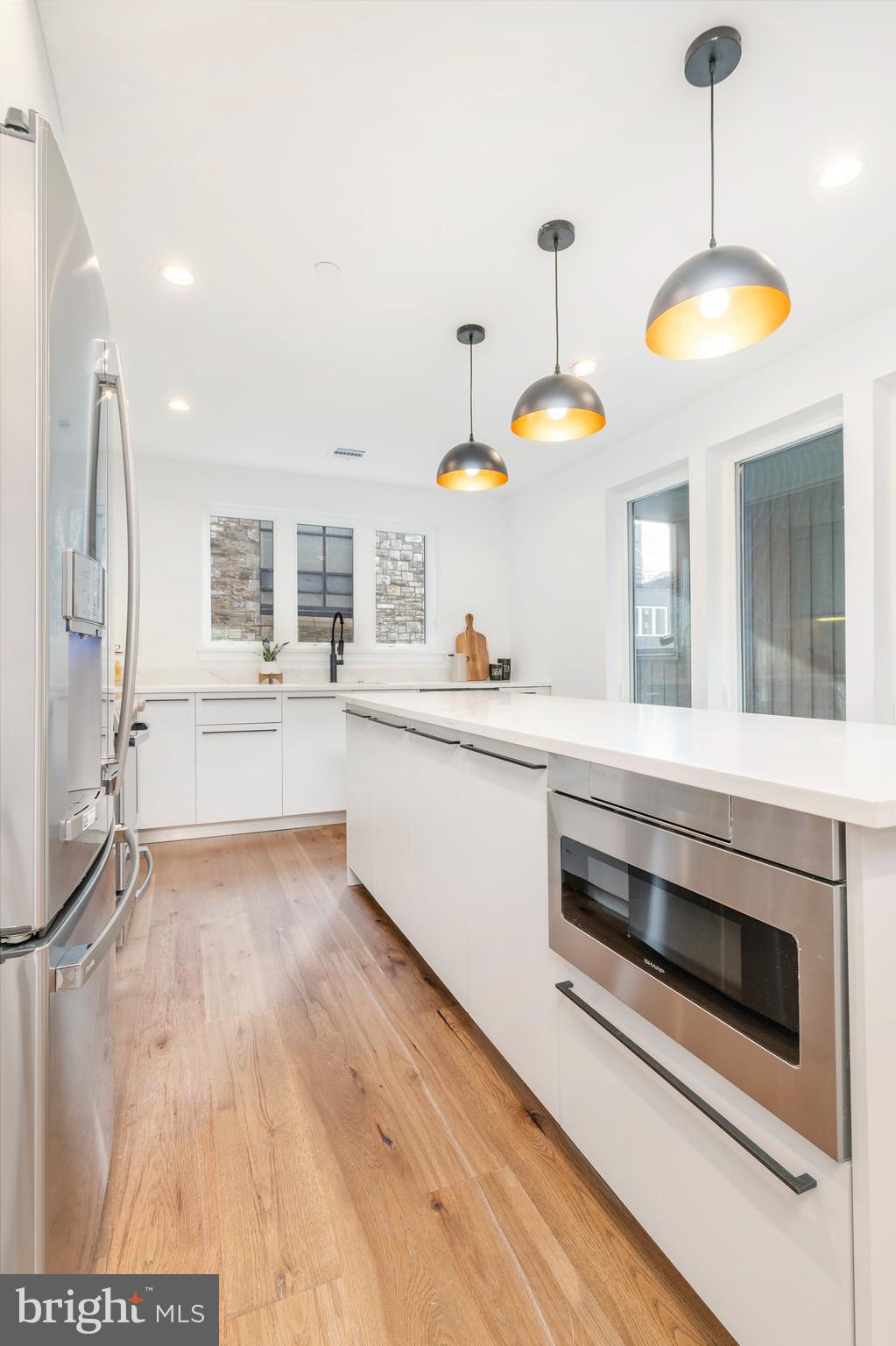310 Reed Street Philadelphia, PA 19147 - Photo 6 of 45 a kitchen with stainless steel appliances a stove a sink and a chandelier