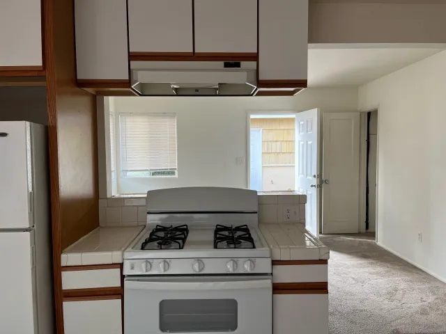 a kitchen with a stove and a refrigerator