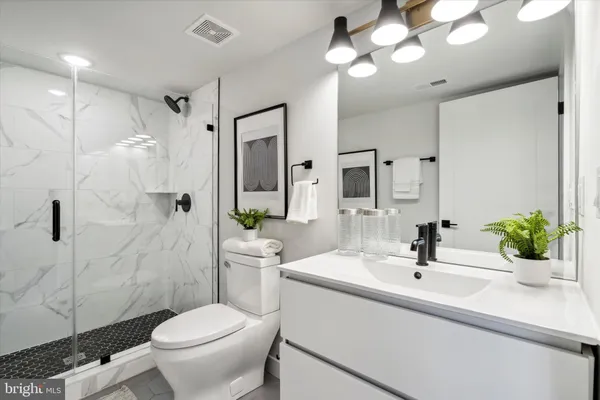 a bathroom with a sink toilet and shower