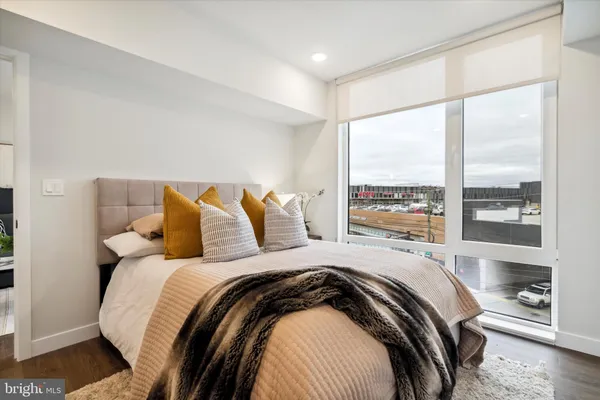 a bed sitting in a bedroom next to a window