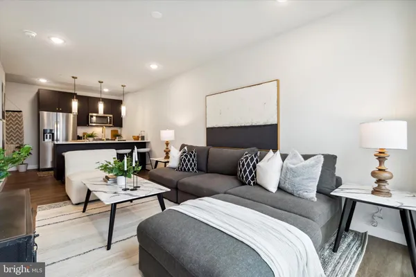 a living room with furniture and a lamp
