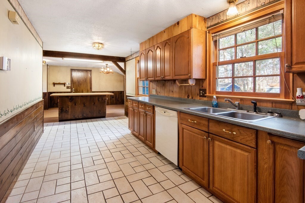 11 Beech Street Oxford, MA 01540 - Photo 16 of 40 a large kitchen with stainless steel appliances a sink and cabinets