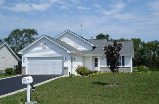 2275 Broadmoor Road South Beloit, IL 61080 - Photo 1 of 4 a front view of a house with a yard and a garage