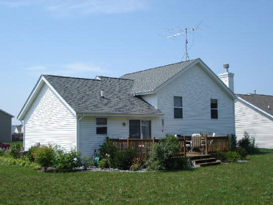 2275 Broadmoor Road South Beloit, IL 61080 - Photo 2 of 4 a front view of a house with a garden and plants