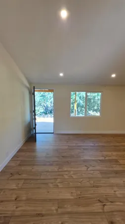 wooden floor in an empty room with a window