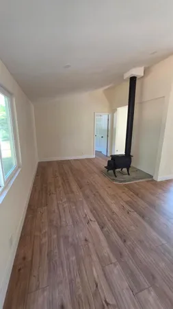 a view of a room with wooden floor