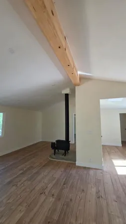 a view of a room with wooden floor