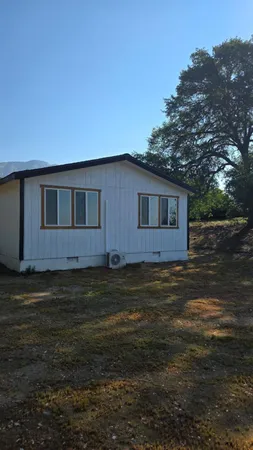a backyard of a house with wooden fence