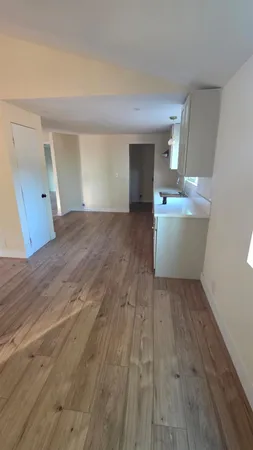 a view of a room with wooden floor and chair