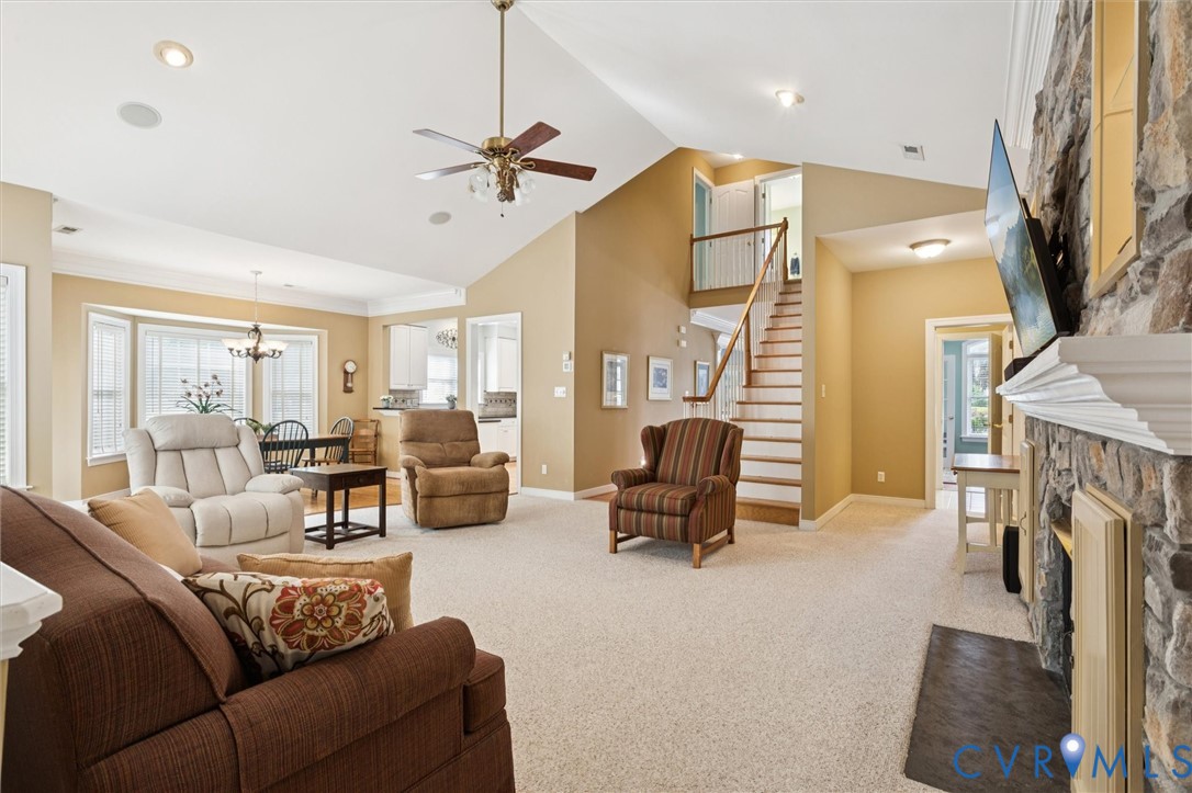 3143 Cider House Road Toano, VA 23168 - Photo 16 of 50 Carpeted living room with stairs, high vaulted cei