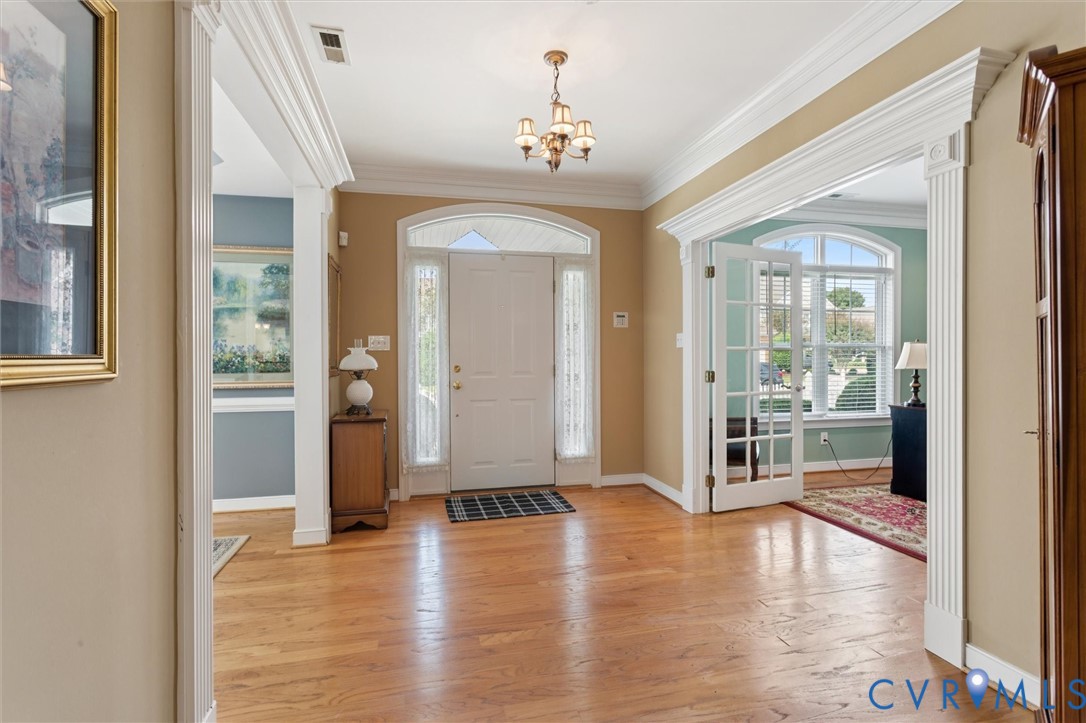 3143 Cider House Road Toano, VA 23168 - Photo 8 of 50 Foyer with light wood-style floors, crown molding,