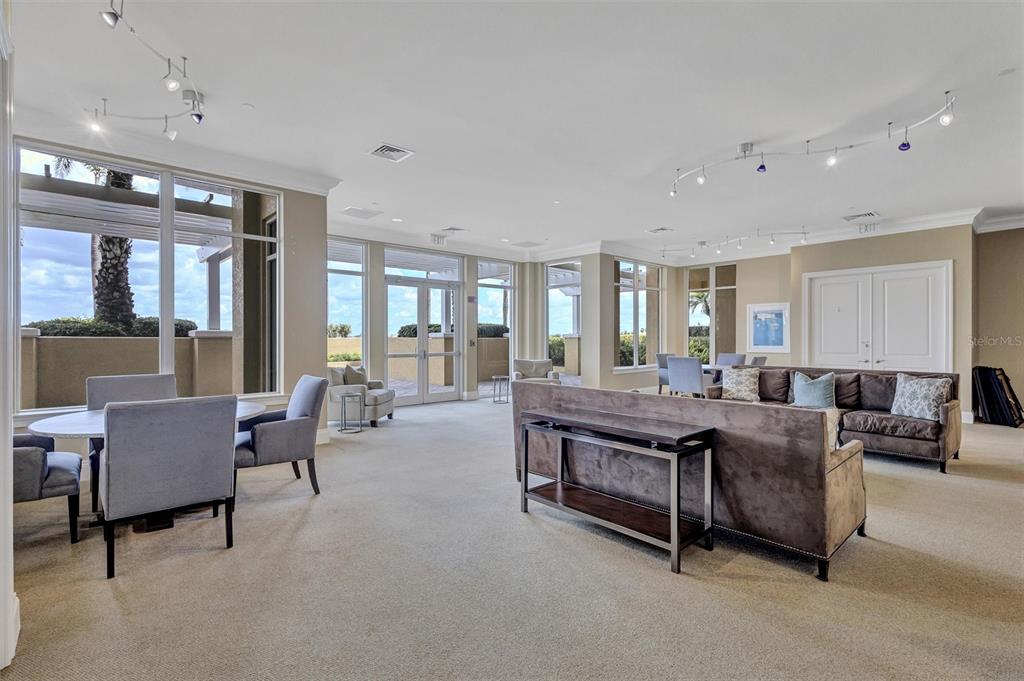 140 Riviera Dunes Way, Unit 206 Palmetto, FL 34221 - Photo 25 of 46 a living room with furniture and a table