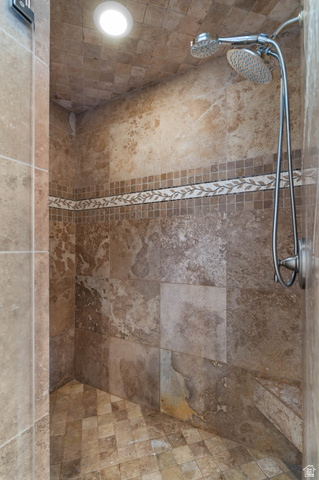 439 East 13540 South Draper, UT 84020 - Photo 21 of 46 Walk-in shower with natural stone-look tile walls, decorative mosaic accent band, dual shower heads, integrated bench, and recessed lighting