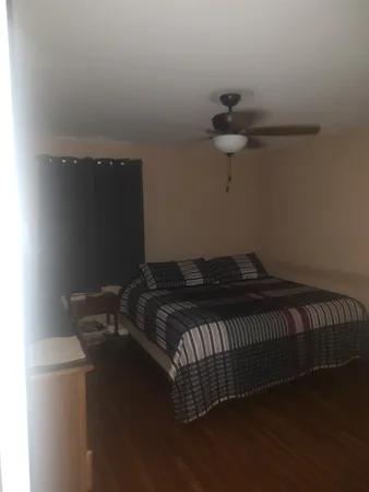 a bed sitting in a bedroom next to a window