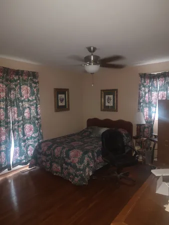 a bedroom with a bed dresser and a window