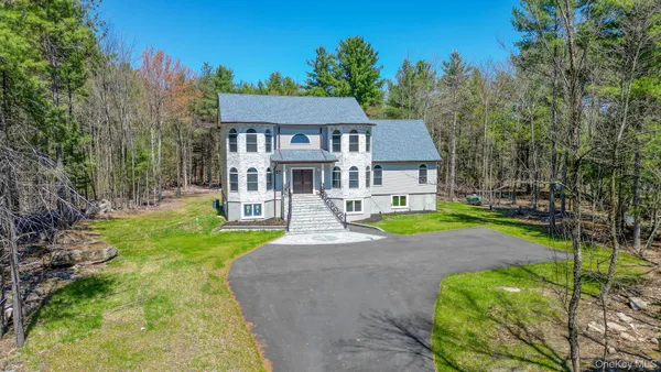 a house with green field in front of it