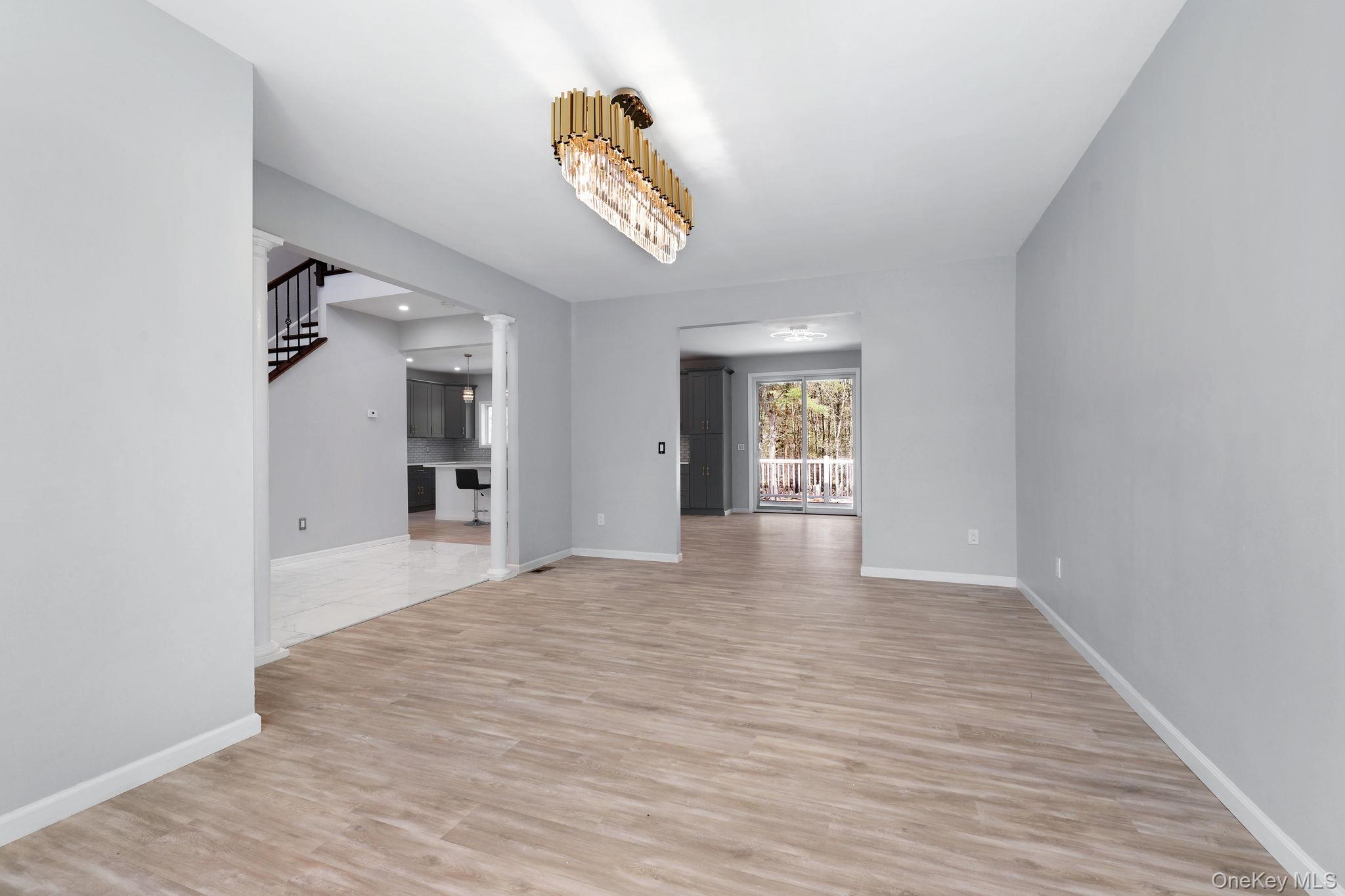 57 Haddock Road Monticello, NY 12701 - Photo 20 of 42 a view of a hallway with wooden floor and a living room