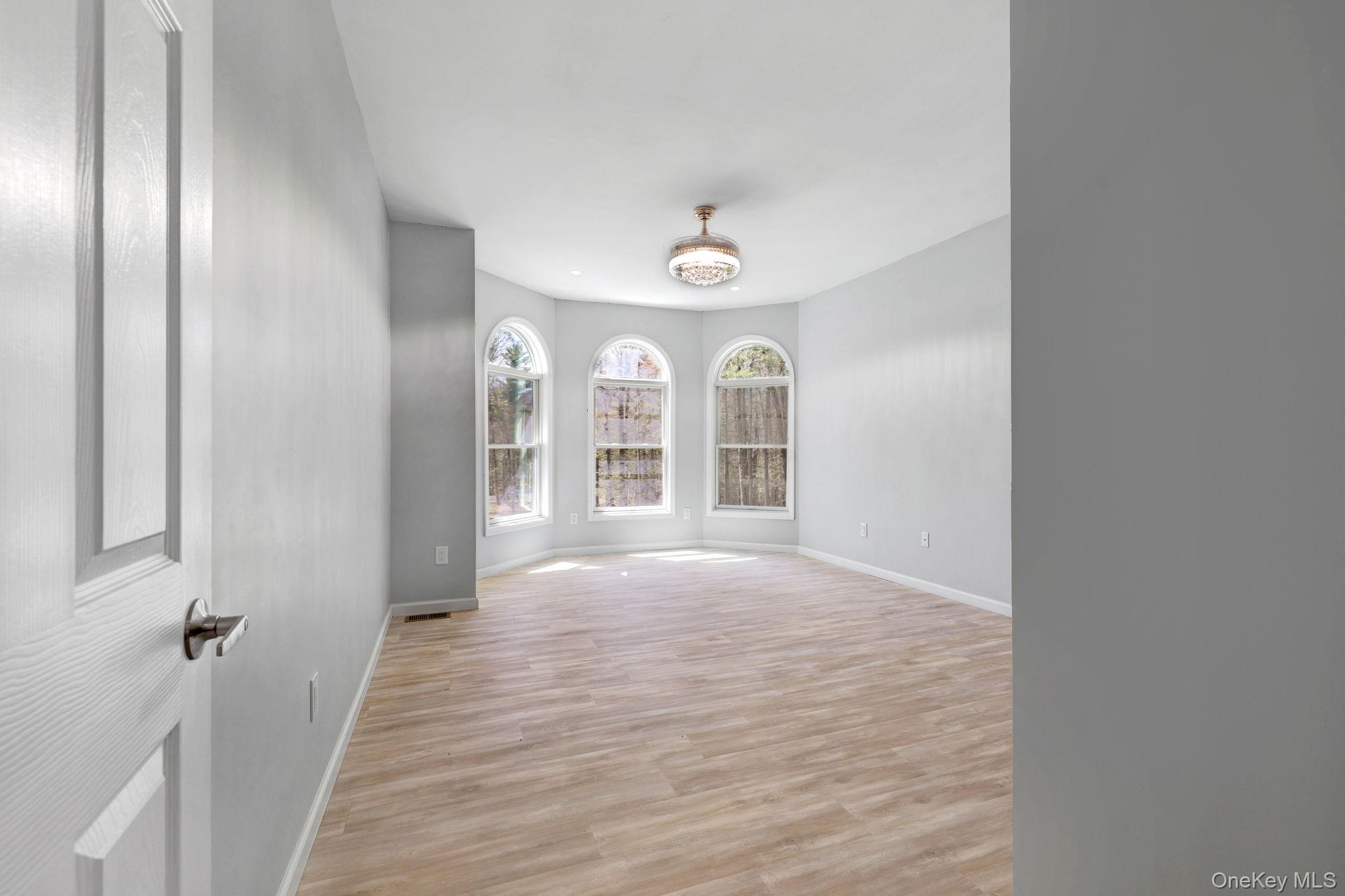 57 Haddock Road Monticello, NY 12701 - Photo 24 of 42 a view of a hallway with wooden floor and chandelier