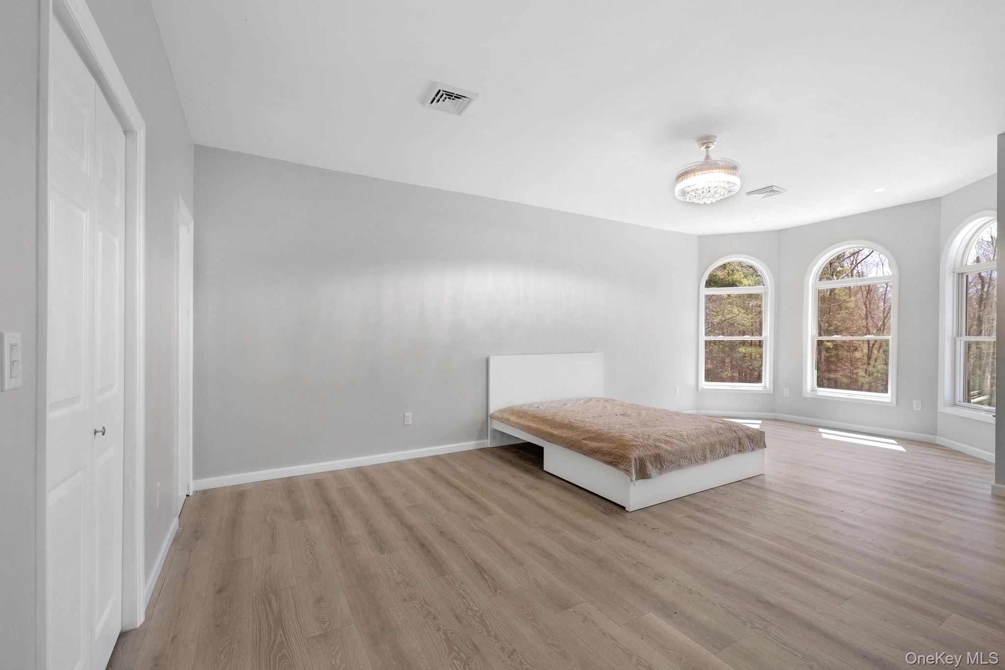 57 Haddock Road Monticello, NY 12701 - Photo 30 of 42 a spacious bedroom with a bed and a window