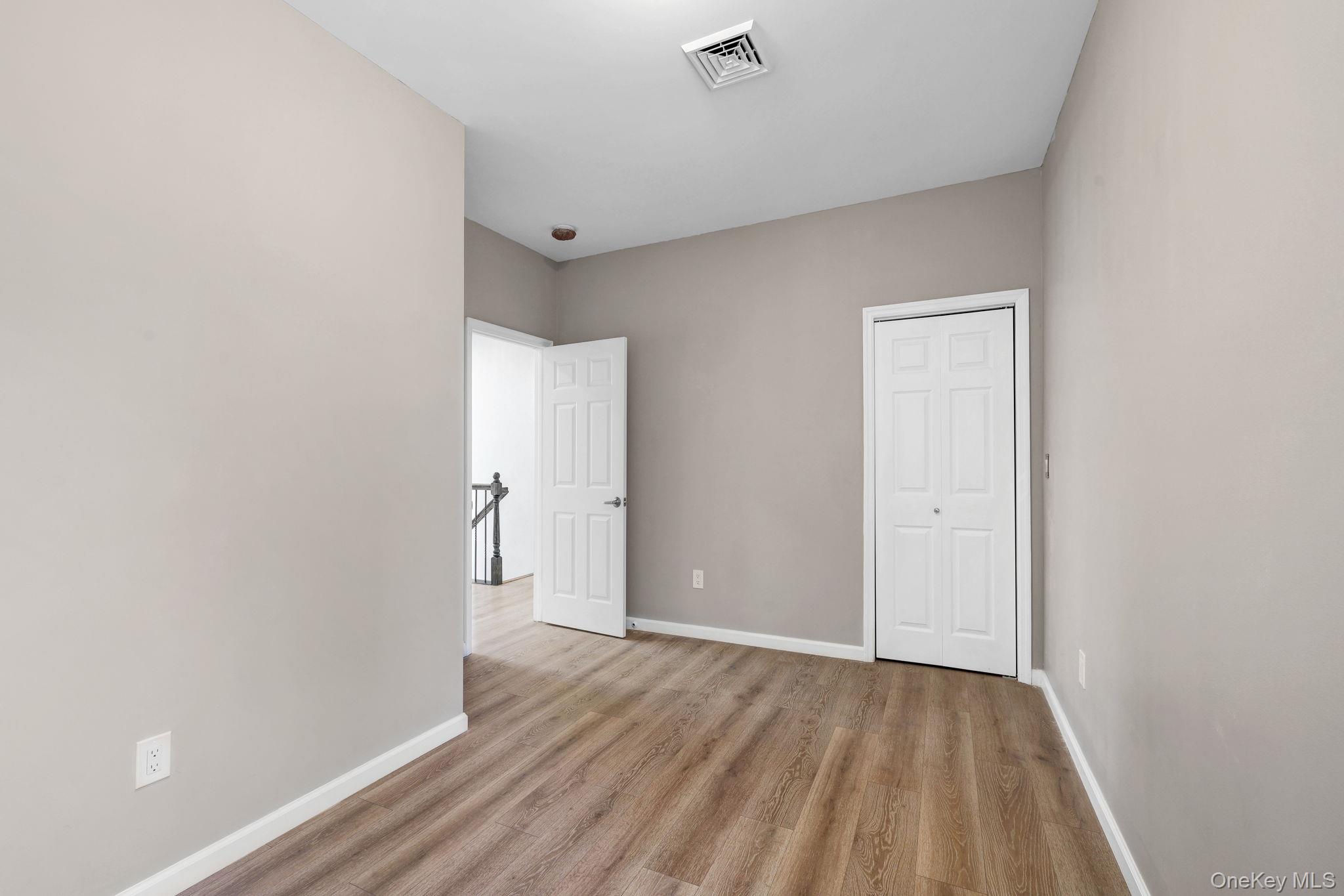 57 Haddock Road Monticello, NY 12701 - Photo 35 of 42 a view of an empty room with wooden floor and a window