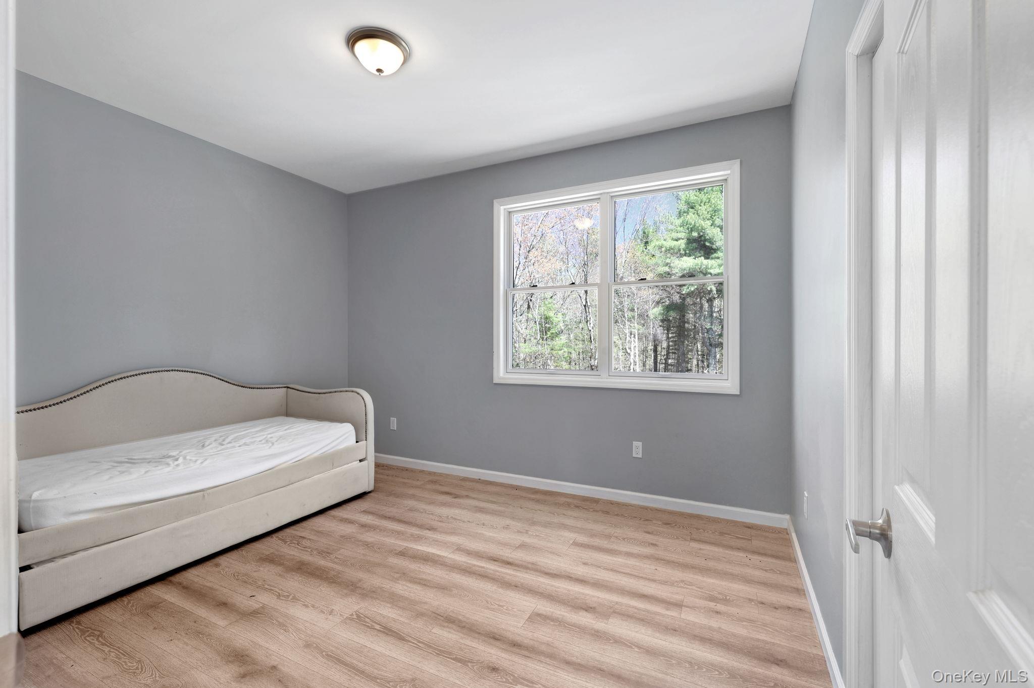 57 Haddock Road Monticello, NY 12701 - Photo 37 of 42 a bedroom with a bed and a window