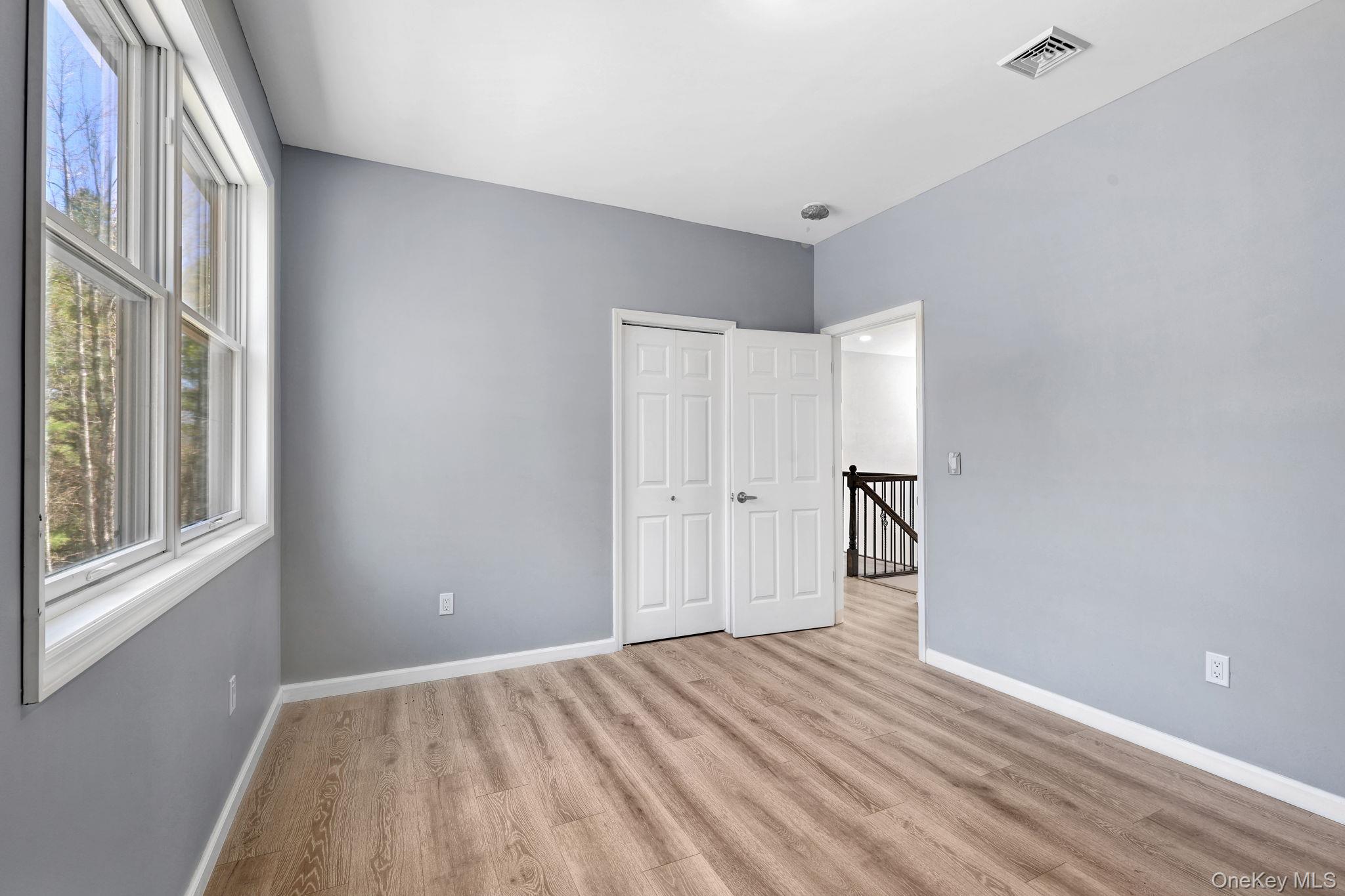 57 Haddock Road Monticello, NY 12701 - Photo 38 of 42 a view of an empty room with wooden floor and a window