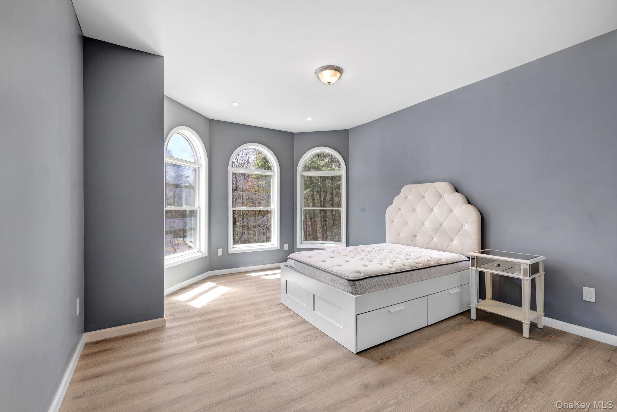 57 Haddock Road Monticello, NY 12701 - Photo 40 of 42 a spacious bedroom with a bed and a large window