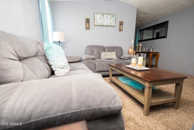 a living room with furniture and flowers