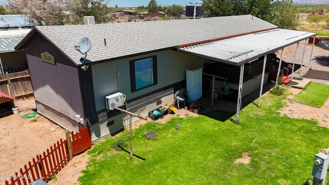 an aerial view of a house with swimming pool and patio