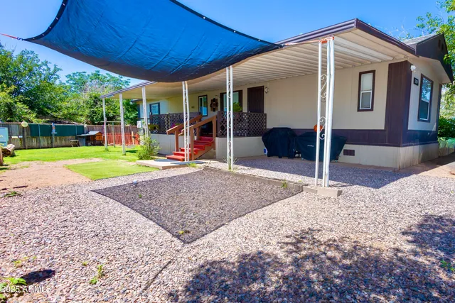 a view of a house with backyard and porch