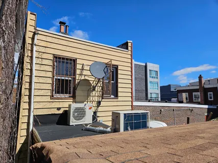 a view of a house with a balcony and refrigerator