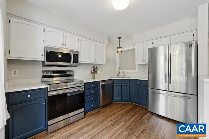 3241 Gateway Circle Charlottesville, VA 22911 - Photo 13 of 35 a kitchen with wooden floors stainless steel appliances and cabinets