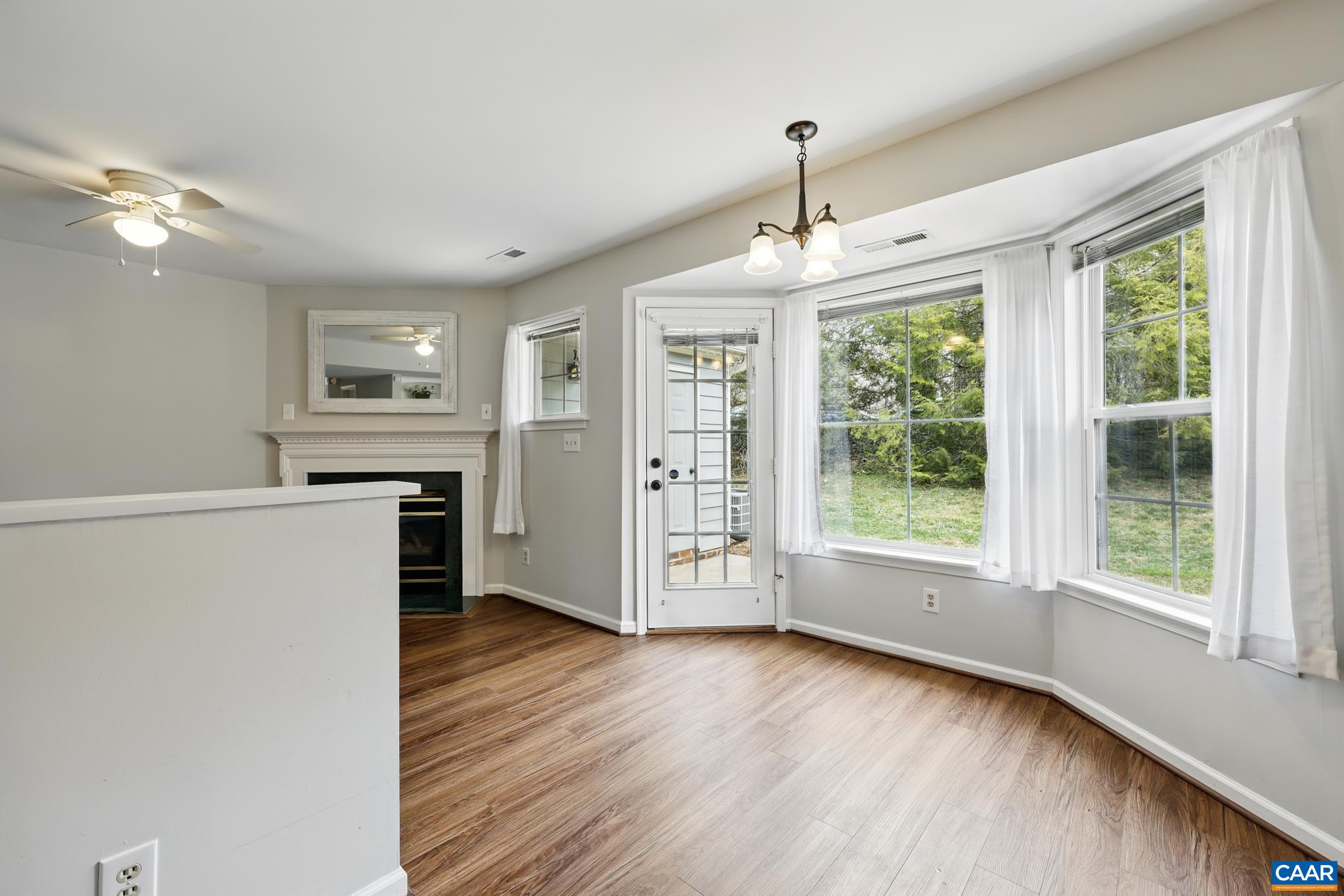 3241 Gateway Circle Charlottesville, VA 22911 - Photo 16 of 35 a view of a kitchen with wooden floor a ceiling fan and windows