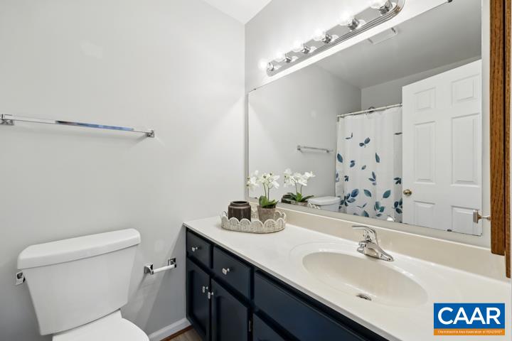 3241 Gateway Circle Charlottesville, VA 22911 - Photo 27 of 35 a bathroom with a sink a toilet and a mirror