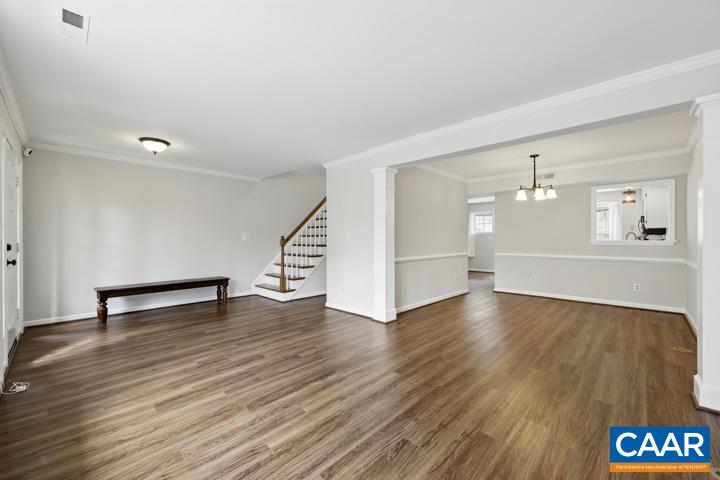 3241 Gateway Circle Charlottesville, VA 22911 - Photo 8 of 35 an empty room with wooden floor and kitchen appliances