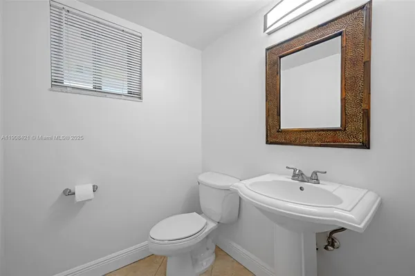 a bathroom with a sink toilet and mirror
