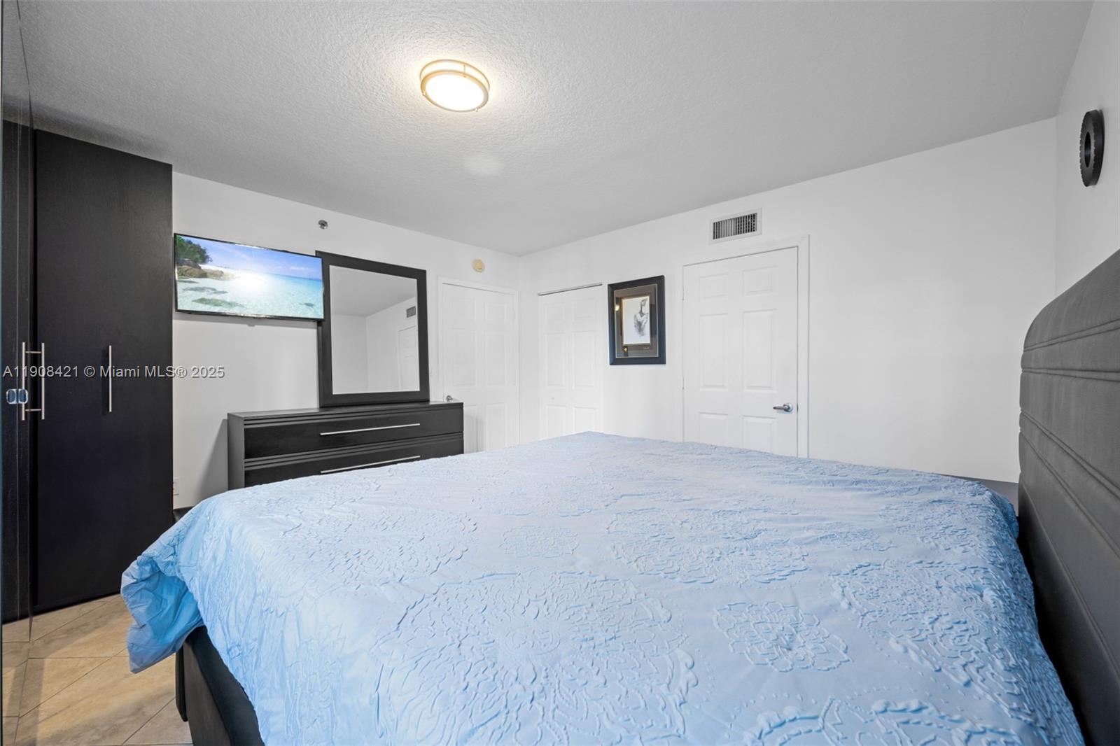 8888 Collins Avenue, Unit 105 Surfside, FL 33154 - Photo 15 of 29 a large bed in a white room
