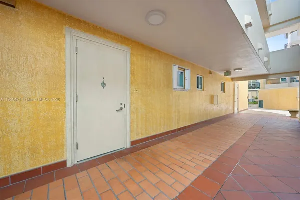 a view of a big room with wooden floor and windows