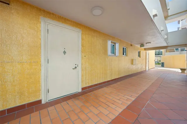 a view of a big room with wooden floor and windows