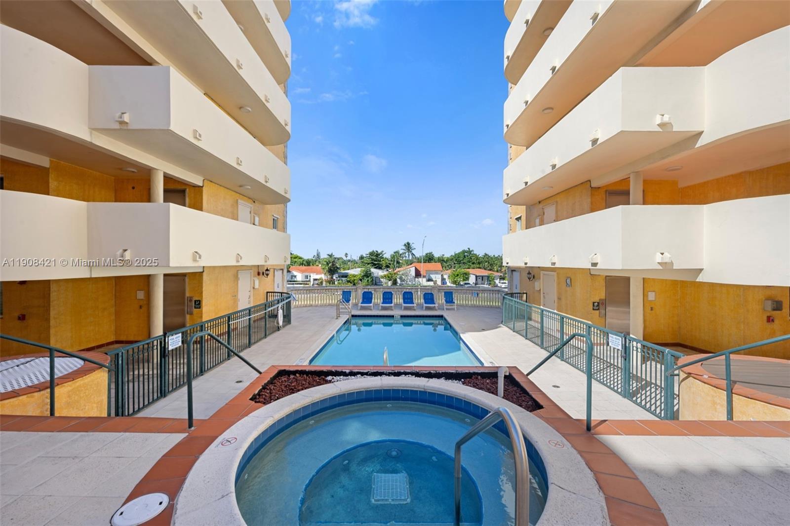 8888 Collins Avenue, Unit 105 Surfside, FL 33154 - Photo 21 of 29 a view of a swimming pool with a lounge chairs
