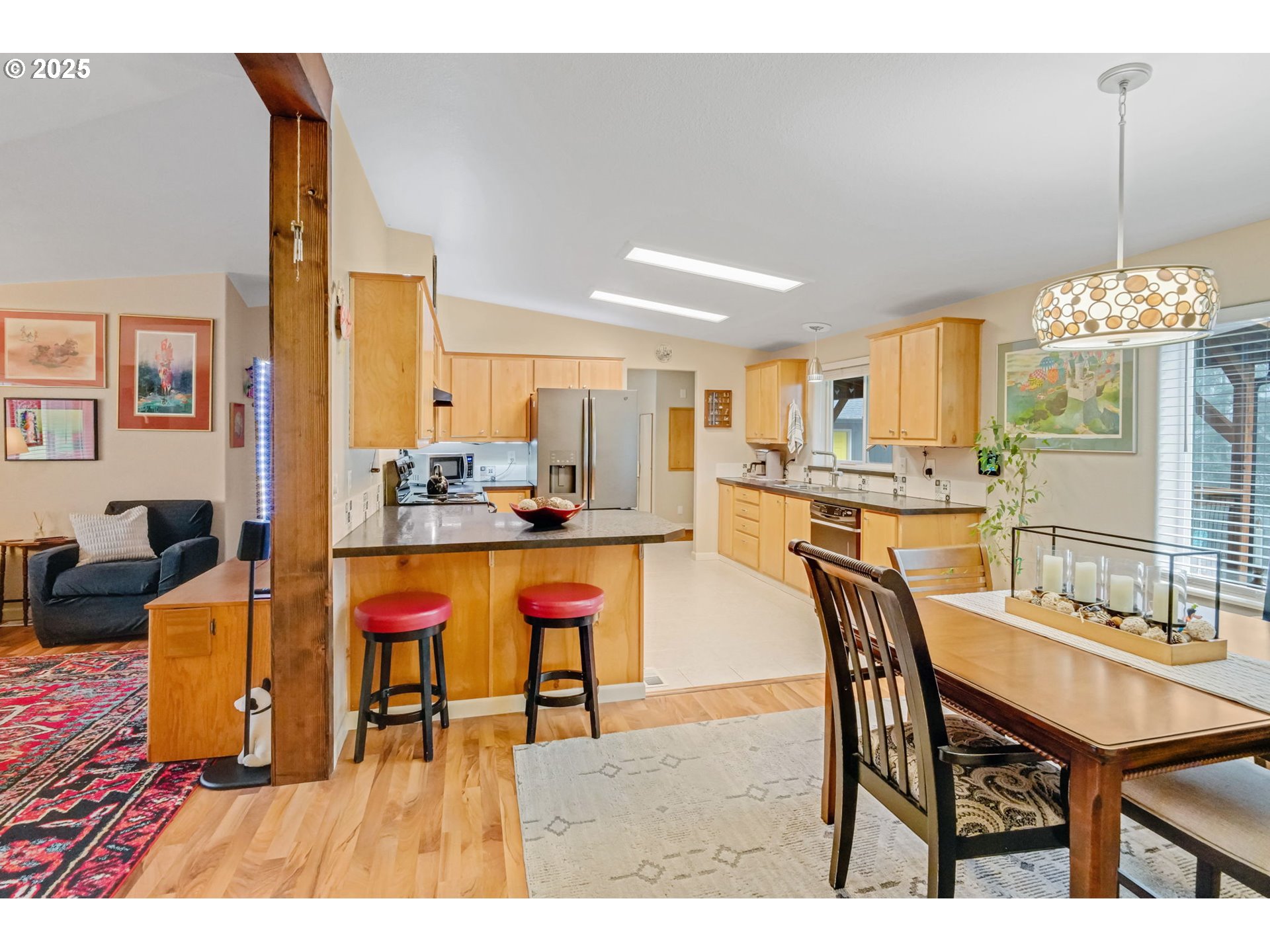 171 Car Road Longview, WA 98632 - Photo 11 of 45 a dining hall with stainless steel appliances kitchen island granite countertop a table chairs and a kitchen view